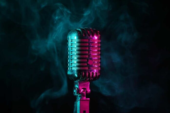 A vintage microphone surrounded by colorful smoke