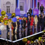 Donald Trump and Melania Trump on stage with balloons; Pramila Bhatt among attendees