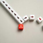 A red warning block surrounded by white blocks with directional arrows