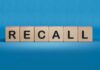 Wooden blocks spelling recall on a blue background