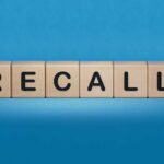 Wooden blocks spelling recall on a blue background