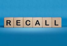 Pet Food Recall Explodes Wooden blocks spelling recall on a blue background