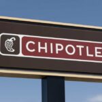 Chipotle restaurant sign against a blue sky
