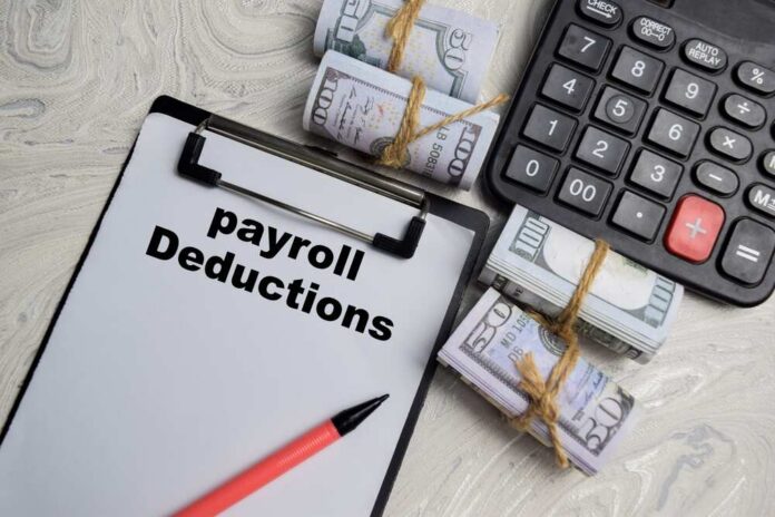 Concept,Of,Payroll,Deductions,Write,On,Paperwork,Isolated,On,Wooden