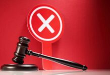 Judge Slams Brakes On Trump AGAIN? Judge's gavel with red cross sign in background