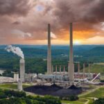 VIDEO: Deadly Explosion at Paper Mill Coal-fired power plant with tall smokestacks at sunset