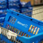 Walmart Snags THIS Hot New Food Item First Blue shopping basket in a cart at a supermarket aisle