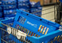 Walmart Snags THIS Hot New Food Item First Blue shopping basket in a cart at a supermarket aisle
