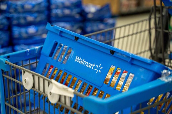 Blue shopping basket in a cart at a supermarket aisle