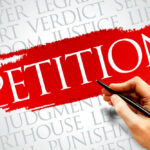 Sign reading petition on red paint