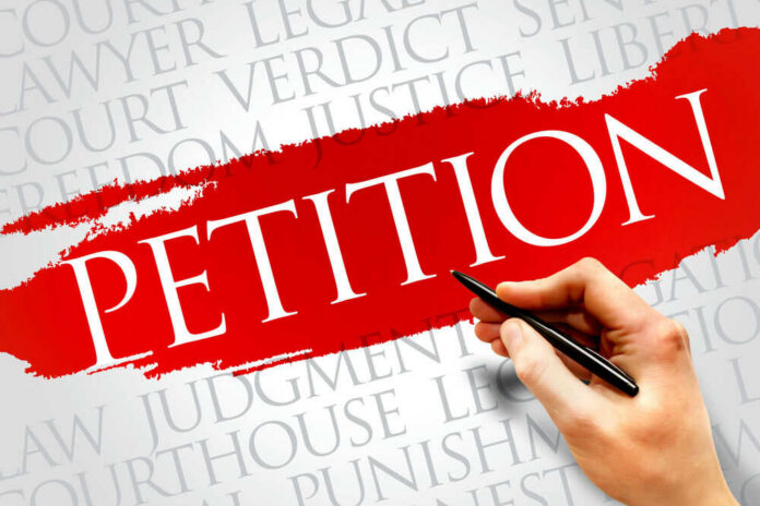 shutterstock_288231671 Sign reading petition on red paint