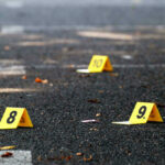 Yellow evidence markers labeled 8, 9, 10 on pavement.