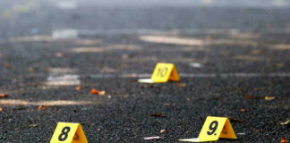 Yellow evidence markers labeled 8, 9, 10 on pavement.