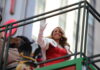 Record Smashed: Mariah Bumped By Country Star (VIDEO) woman in red dress waving from parade float