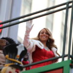 Record Smashed: Mariah Bumped By Country Star (VIDEO) woman in red dress waving from parade float