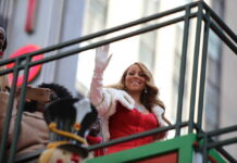 Record Smashed: Mariah Bumped By Country Star (VIDEO) woman in red dress waving from parade float