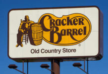 What’s Cracker Barrel Plotting With THIS Change Now? Cracker Barrel Old Country Store sign featuring a man sitting next to a barrel