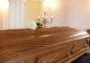 Shock Death Rocks Sports World A wooden casket with a white rose placed on top in a solemn setting