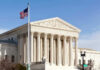 Roberts Blasts Trump, But Trump Wins Anyway U.S. Supreme Court building with American flag.