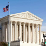 Roberts Blasts Trump, But Trump Wins Anyway U.S. Supreme Court building with American flag.