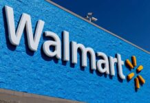 Holiday Shock: Walmart Rolls Two Into One Walmart store sign on a blue wall