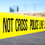 Midnight Gunfire Shocks Block Party Police do not cross tape stretched across an outdoor scene