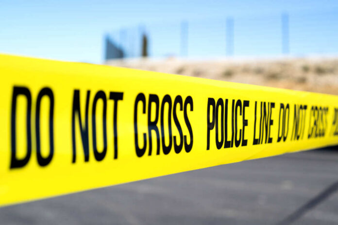 Police,Line,At,Crime,Scene Police do not cross tape stretched across an outdoor scene