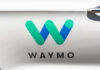 Musk Torches Waymo: Robotaxi War Waymo logo displayed on a vehicle