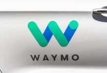 Musk Torches Waymo: Robotaxi War Waymo logo displayed on a vehicle