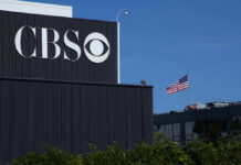 CBS building with American flag in background.