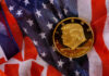 Buy High, Spend Low? Trump Coin Whiplash A gold commemorative coin featuring a profile of Donald Trump on an American flag background