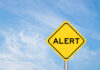 Mike Rowe’s Dire Warning: Clocks Ticking Yellow alert sign against a blue sky