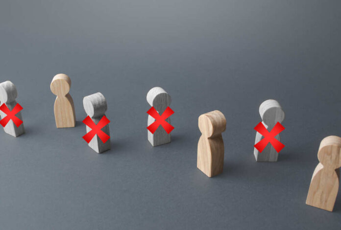 Wooden figures representing people with red crosses indicating exclusion