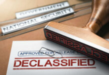Declassified stamp on government document with paperclip