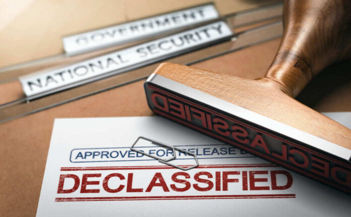 Declassified stamp on government document with paperclip