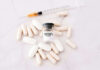 Fentanyl citrate vial surrounded by various pills and syringe.