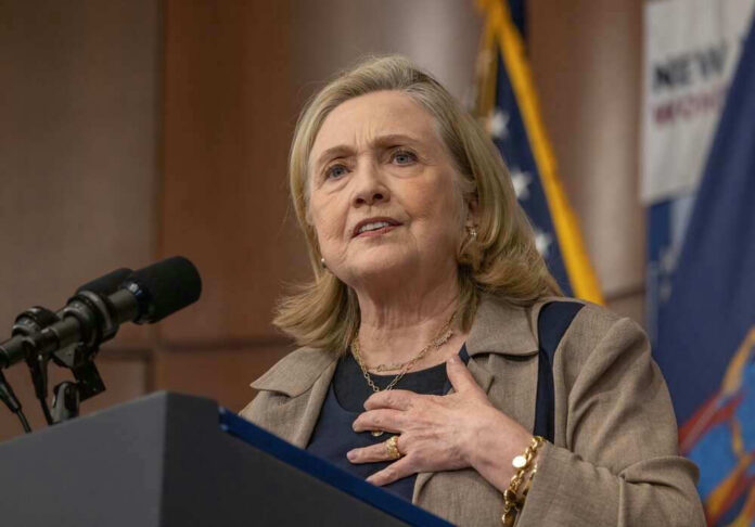 Hillary Clinton speaking at a podium with a microphone