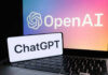 OpenAI BUGGED – FBI Steps In OpenAI ChatGPT logos on laptop and smartphone screens.