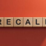 Vehicle Headlights Go Dark – Massive Recall Wooden letter tiles spelling recall on an orange background