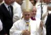 Catholic bishop in white vestments holding a crosier