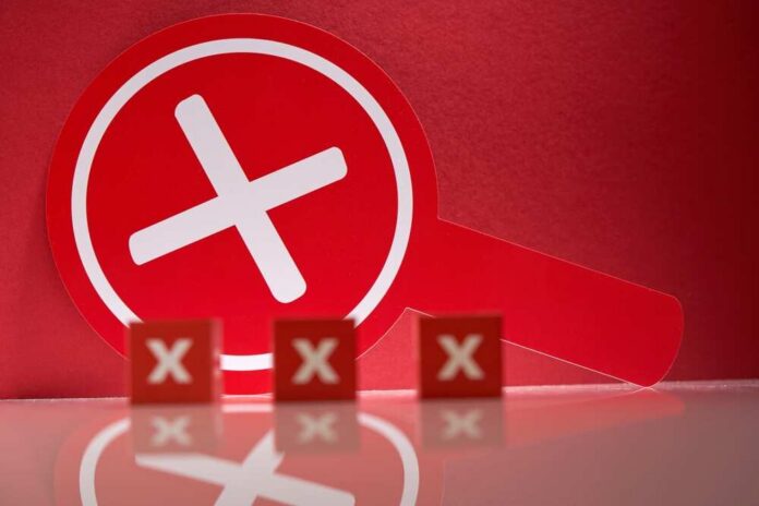 Red,Round,Placard,With,Cross,Sign,Means,Rejection.,Placard,With A red magnifying glass with a cross symbol against a red background