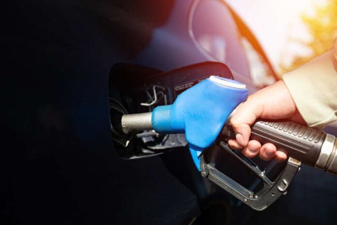 Man,Filling,Gasoline,Fuel,In,Car,Holding,Pump.,Closeup,On