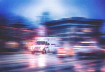 Survivor Leaps As Car Crashes Ambulance speeding through city street at night