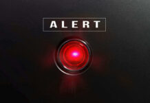 ALERT: Patient Records Exposed Red alert light against black background, text ALERT.