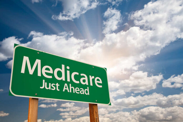 Medicare,Green,Road,Sign,Over,Dramatic,Clouds,And,Sky. Green road sign indicating Medicare is just ahead